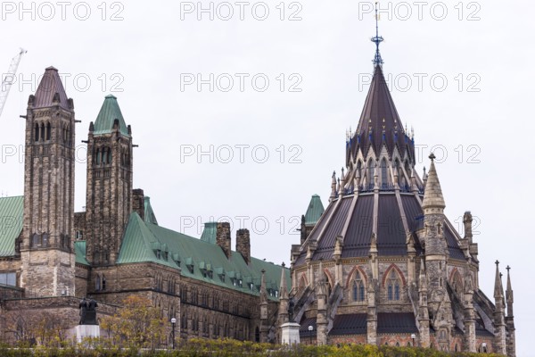 The Canadian Parliament Building with gothic architecture and towers against a cloudy sky in Ottawa, Ontario, Canada, North America