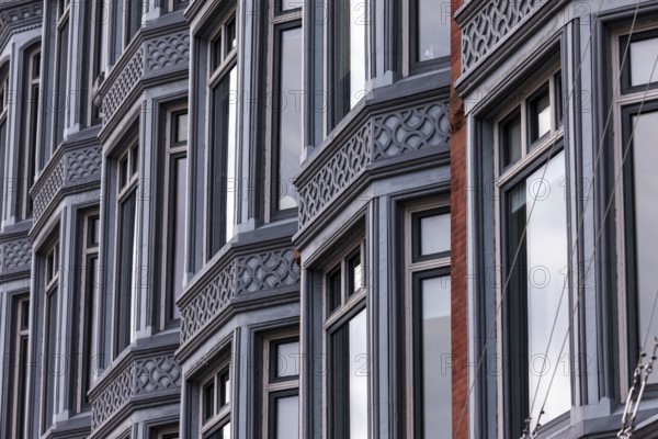Facade of a building with a series of windows and intricate architectural designs, reflecting a structured urban style in Ottawa, Ontario, Canada, North America