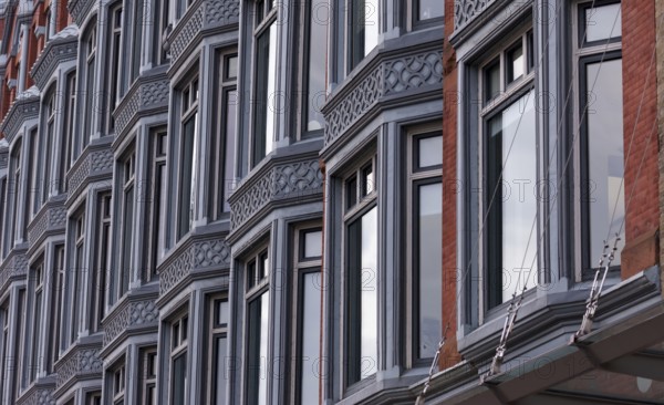 Close-up of a building facade with multiple windows and ornate architectural details, featuring a modern urban feel in Ottawa, Ontario, Canada, North America