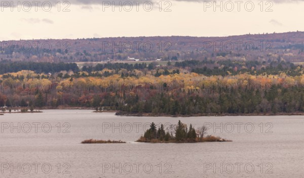 The Ottawa River with small islets surrounded by colorful autumn trees and hills in Ottawa, Ontario, Canada, North America