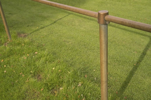 Borken, NRW, Germany, Bronze colored metal railing creating a barrier in a park with lush green grass