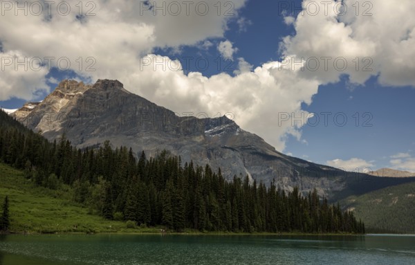 The Canadian Rocky Mountains and forests framing Emerald Lake with a sky full of clouds inside Yoho National Park, British Columbia, Canada, North America