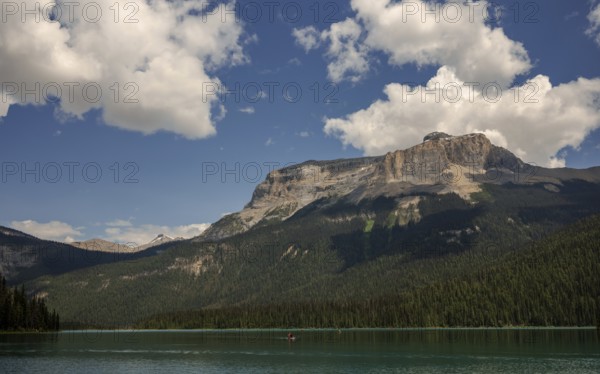 Expansive Emerald Lake surrounded by the Canadian Rocky Mountains and forests under a cloudy sky inside Yoho National Park, British Columbia, Canada, North America