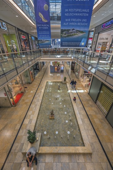 Shops and fountain with frog king in Forum Allgäu, Kempten, Allgäu, Swabia, Germany
