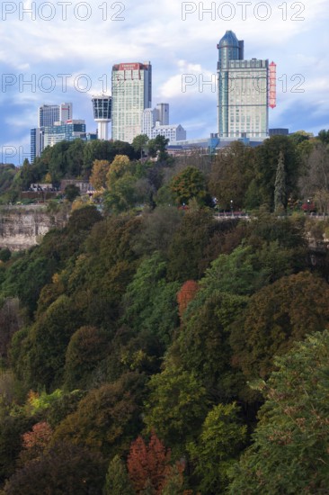 City skyscrapers rise above lush, colorful trees and natural landscape in Niagara Falls, Ontario, Canada, North America