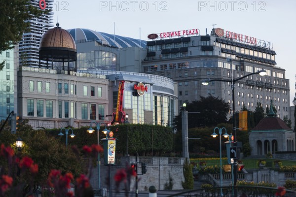 Crowne Plaza and surrounding buildings with evening lights and urban surroundings in Niagara Falls, Ontario, Canada, North America