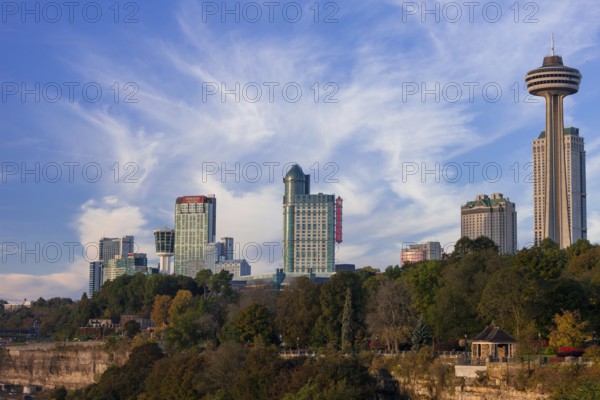 Urban skyline with modern skyscrapers set against vibrant blue skies and greenery in Niagara Falls, Ontario, Canada, North America