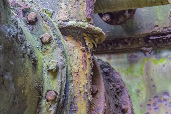 Weathered rundown industrial detail with old corroded metal tubes and fittings