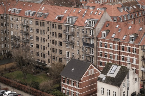 Dense urban scene with red tile roofed residential buildings under an overcast sky in Aarhus, Denmark, Northern Europe