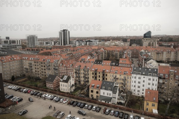 Panoramic urban view with uniform red-tiled rooftops under a gray sky in Aarhus, Denmark, Northern Europe