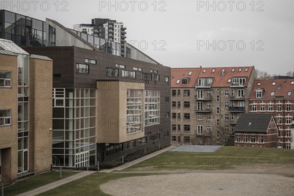 Contrasting modern and traditional buildings in an urban setting with a gray sky in Aarhus, Denmark, Northern Europe