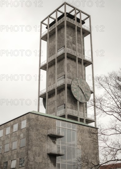 Tall concrete clock tower with minimalistic design against a cloudy sky in Aarhus, Denmark, Northern Europe