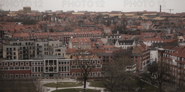 Aerial view of a city with red-tiled rooftops under an overcast sky in Aarhus, Denmark, Northern Europe