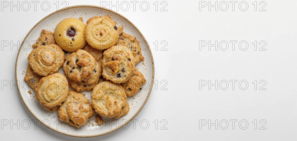 A top-down shot showcases a variety of golden-brown cookies arranged on a speckled plate against a white backdrop, perfect for food-related content, AI generated