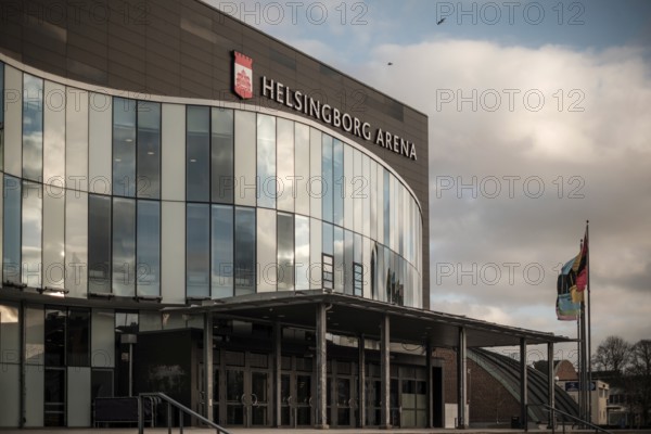 Helsingborg Arena featuring a glass facade, flags, and situated under cloudy weather in Helsingborg, Sweden, Scandinavia, Northern Europe