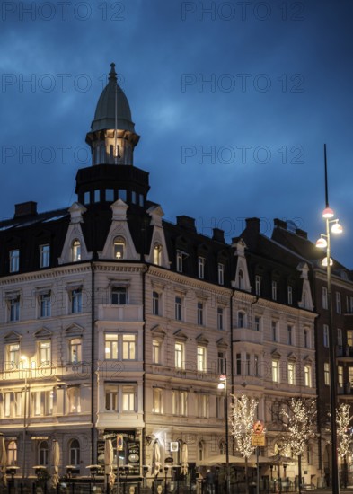 An elegant historic building with illuminated windows against a blue evening sky in Helsingborg, Sweden, Scandinavia, Northern Europe