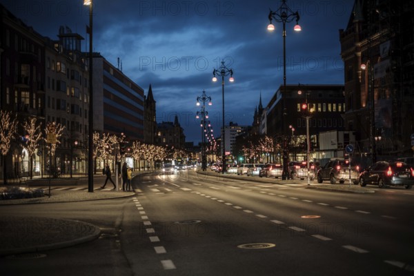 Nighttime urban road lined with illuminated trees and passing cars in Helsingborg, Sweden, Scandinavia, Northern Europe