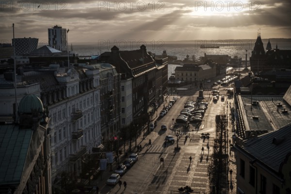 A street leading to the Oresund Strait under a dramatic sunset and clouds as seen from Helsingborg, Sweden, Scandinavia, Northern Europe
