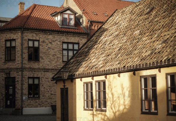Buildings with contrasting rooftops and sunlight casting shadows, an urban architectural scene in Helsingborg, Sweden, Scandinavia, Northern Europe