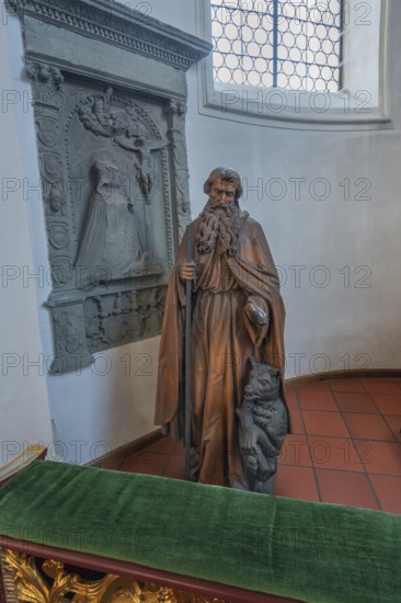 Church of St Gallus and Ulrich, figure of St Gallus with the bear next to an epitaph, Kisslegg, Allgäu, Baden-Württemberg, Germany