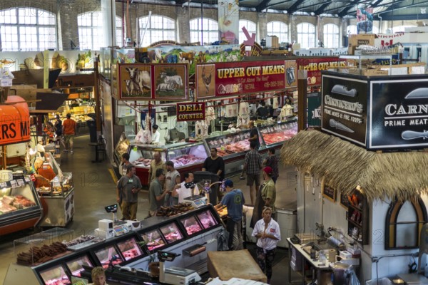 A bustling indoor market at St. Lawrence Market, with meat vendors and colorful displays in Toronto, Ontario, Canada, North America