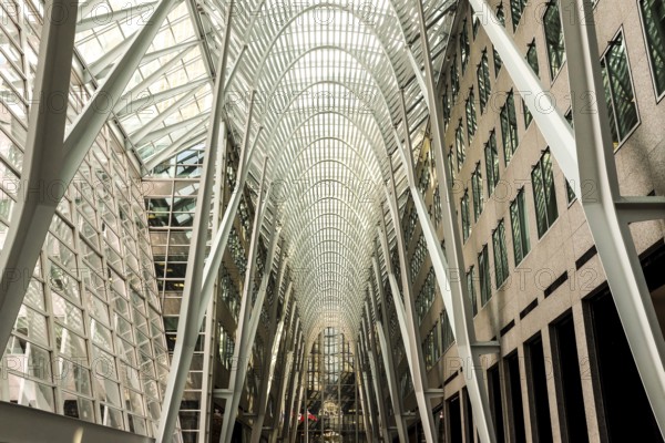 Modern interior of Brookfield Place with a glass ceiling and steel arches creating a symmetrical design in Toronto, Ontario, Canada, North America