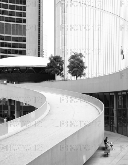 A curved ramp between modern buildings in a black and white setting in Toronto, Ontario, Canada, North America