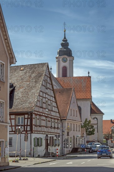 Pointed gable house with half-timbering and St Gallus and Ulrich church, Kisslegg, Allgäu, Baden-Württemberg, Germany
