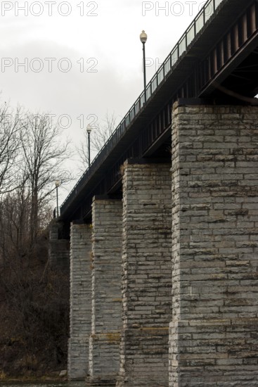Image of a bridge with massive stone columns under an overcast sky, creating a somber industrial feel in St. Marys, Ontario, Canada, North America
