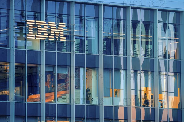 Jan 16, 2025 - Lisbon, Portugal: Day view of IBM office building with glowing logo and sleek glass exterior. Illuminated interior spaces and reflections, innovative spirit and global presence of renowned technology corporation, corporate life