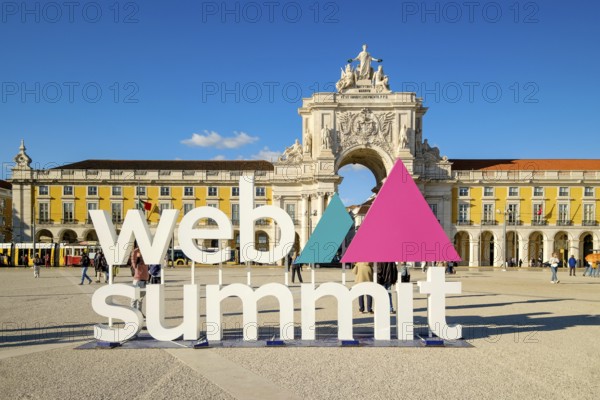 Nov 13, 2024 - Lisbon, Portugal: Web Summit installation in Praca do Comercio with famous Rua Augusta Arch and historic yellow buildings on sunny day. Technology and historic heritage, global event, innovation, entrepreneurship, future of technology