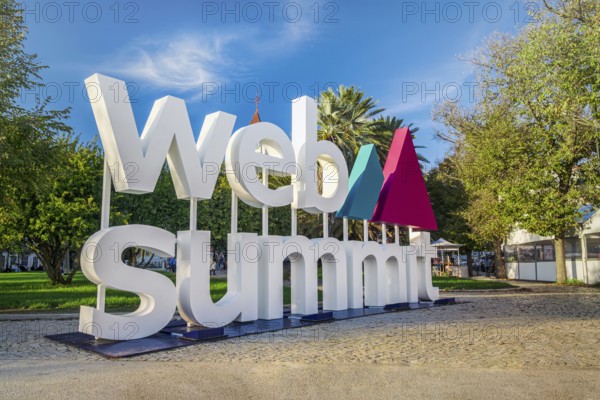 Nov 6, 2024 - Lisbon, Portugal: Large Web Summit sign displayed outdoors in park on sunny day under clear blue sky. Major annual technology conference hosted in Portuguese capital city. Internet technology, emerging technology, marketing, AI solution