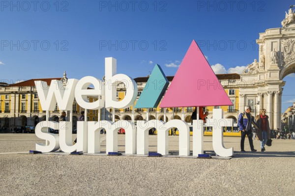 Nov 13, 2024, Lisbon, Portugal: Colorful Web Summit sign against classic architecture of Praca do Comercio. Internet technology, emerging technology, marketing, AI solutions, innovation and networking, discussions on technology and ideas