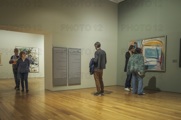 Jan 13, 2024 - Lisbon, Portugal: Visitors engage with diverse paintings in exhibitions at Berardo Collection Museum, navigating halls, reading information panels and observing artwork of Portuguese and international art from 20th and 21st centuries