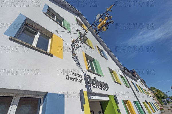 Blue sky, Hotel-Gasthof-Ochsen with nose sign and colourful windows in Kisslegg, Allgäu, Baden-Württemberg, Germany