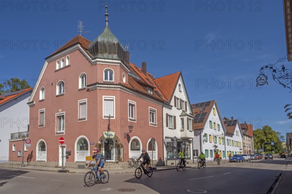 Blue sky, street with cyclists, pointed gable houses and ZAPPA BAR in Kisslegg, Allgäu, Baden-Württemberg, Germany