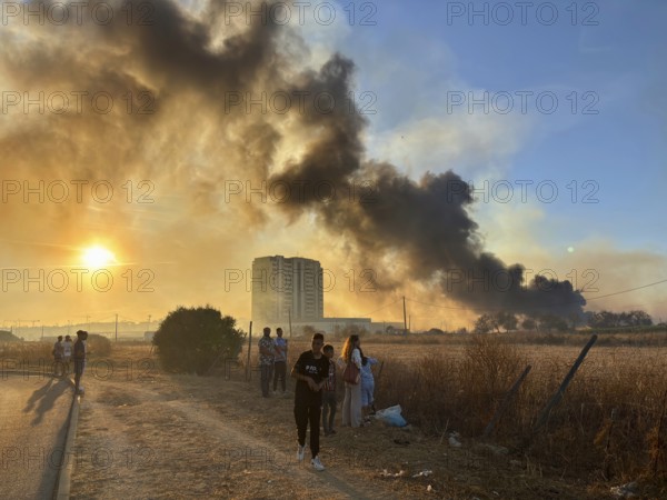 Faro, Algarve - September 21, 2025: People watching a big fire in the suburbs of Faro, capital city of Algarve. People watching
