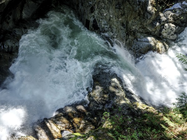 Powerful water flow over rocks in a forest setting inside Cascade Falls Regional Park, Deroche, British Columbia, Canada, North America