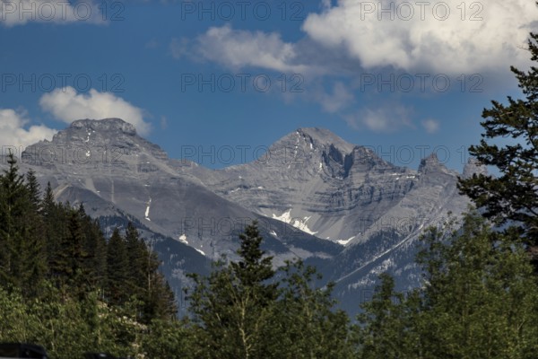 Rocky mountain peaks under a blue sky with clouds inside Yoho National Park in British Columbia, Canada, North America