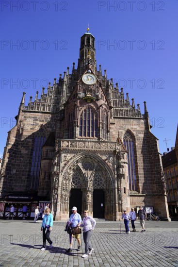 Impressive gothic church facade with people in the city centre under a clear sky, Nuremberg, Middle Franconia, Franconia, Bavaria, Germany