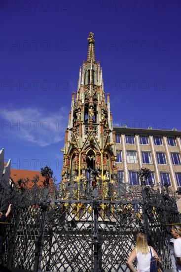 Detailed Gothic fountain with colourful decoration in front of a clear blue sky, Nuremberg, Middle Franconia, Franconia, Bavaria, Germany