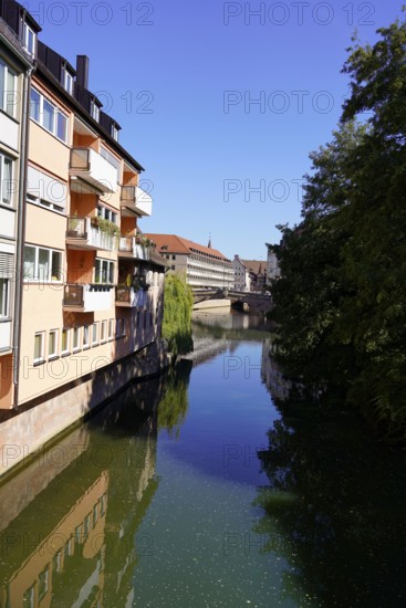 View of a river between buildings and a bridge under a bright blue sky, Nuremberg, Middle Franconia, Franconia, Bavaria, Germany