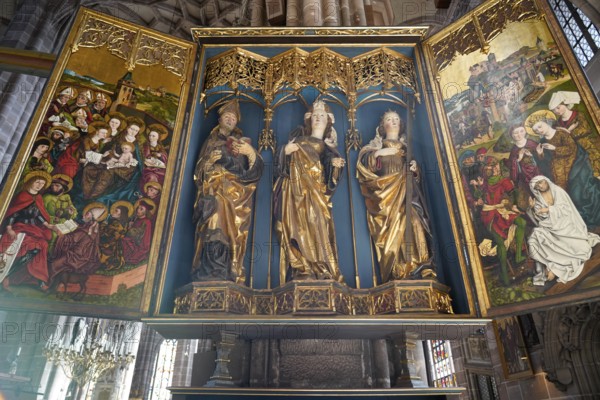 Ornate church altar with gilded figures of saints and colourful paintings, Church of St. Lawrence, Nuremberg, Middle Franconia, Franconia, Bavaria, Germany