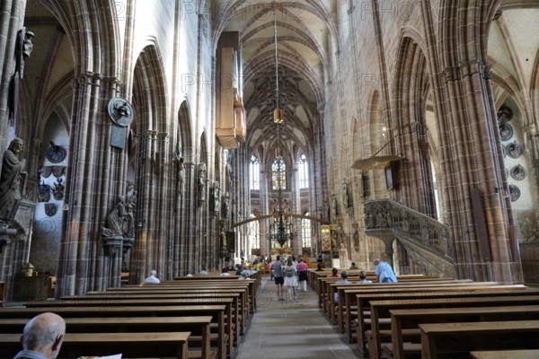 Nave with high vaults, benches and people inside a historic church, Church of St. Lawrence, Nuremberg, Middle Franconia, Franconia, Bavaria, Germany