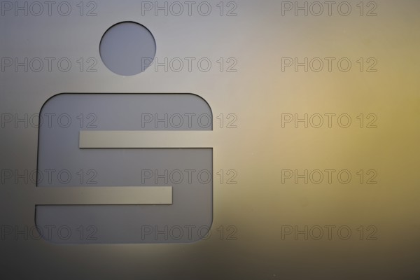 Metallic symbol half in the light on a gold-coloured background, Nuremberg, Middle Franconia, Franconia, Bavaria, Germany