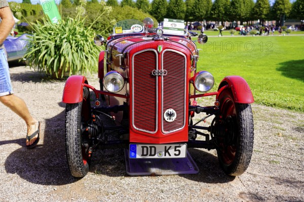 DKW, year of construction 1938, Oldtimer Classic, Gala International Concours d'Elegance Schwetzingen 2025, Germany, Europe, Red classic car in front view on a gravel path with green garden in the background
