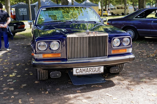 Oldtimer Classic, Gala International Concours d'Elegance Schwetzingen 2025, Germany, Europe, Dark blue Rolls-Royce Camargue presented as a luxurious classic car on a shady square