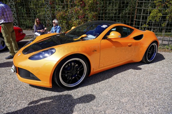 Artega, Year 2011, Oldtimer Classic, Gala International Concours d'Elegance Schwetzingen 2025, Germany, Europe, Orange Artega sports car in elegant side view in sunshine at an exhibition