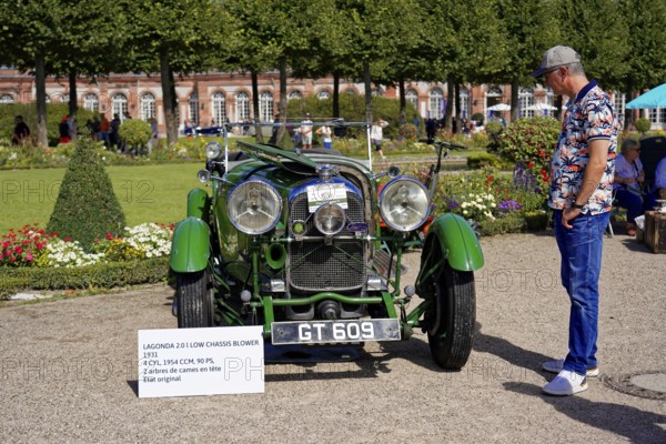 Oldtimer Classic, Gala International Concours d'Elegance Schwetzingen 2025, Germany, Europe, Green classic car on a sunny exhibition site with a man admiring it