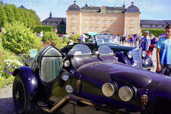 Oldtimer Classic, Gala International Concours d'Elegance Schwetzingen 2025, Germany, Europe, Black classic car with purple details in front of a historic building at an event